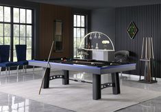 a pool table in a living room with blue chairs