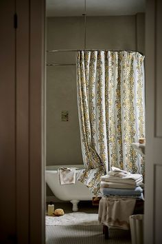 a bath tub sitting next to a window in a bathroom