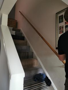 a man is walking down the stairs in his house