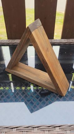 two pieces of wood sitting on top of a table next to a window sill