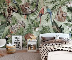 a bedroom decorated with tropical wallpaper and jungle animals