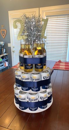 a cake made out of beer bottles on top of a wooden table