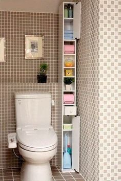 a white toilet sitting in a bathroom next to a shelf filled with books and magazines