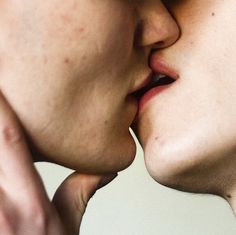 two people are kissing each other with their noses close together