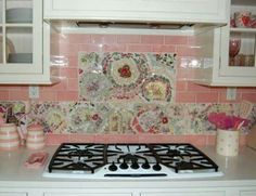 a stove top oven sitting inside of a kitchen next to white cabinets and cupboards