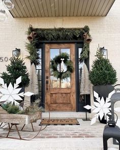 the front door is decorated for christmas with wreaths and snowflakes