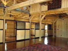 the inside of a building with wooden walls and doors on either side of the room