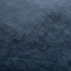 a close up view of the texture of a dark blue fabric