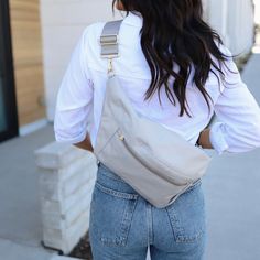 Enjoy the luxury of going hands-free with our Grey Fanny Pack. Designed to be ultra comfortable, this belt bag includes an air cushioned back panel and extra wide strap. Fun details include a key clip, and a rear water resistant phone pocket. Our Grey is light, crisp and elegant. The natural tones give you the ultimate style flexibility! Pairs great with your favorite jeans and tee. Mom Purses, Black Fanny Pack, Fabric Stains, Travel Budget, Waterproof Phone, Key Clip, Pink Feathers, Slim Wallet, Love Is Free