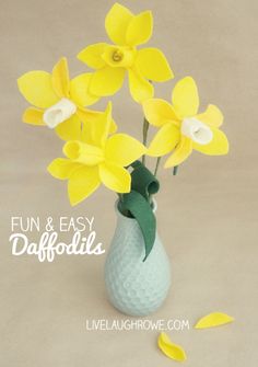 yellow daffodils in a blue vase with text overlay that says fun and easy daffodils