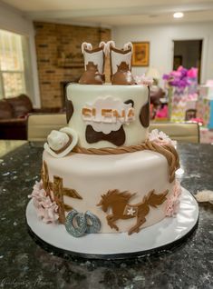 a birthday cake decorated with cowboy boots and horses