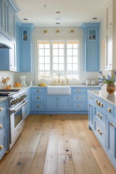 a kitchen with blue cabinets and wooden floors