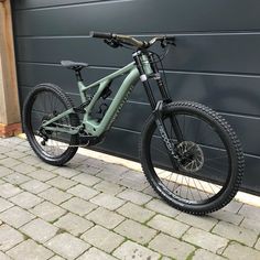 a mountain bike parked in front of a garage door