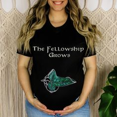 a woman wearing a black t - shirt with the words, the fellowship grows on it