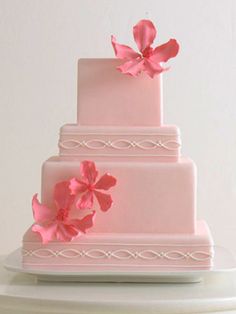 a three tiered cake with pink flowers on top