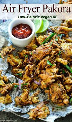 an air fryer pakora on a plate with ketchup and dipping sauce