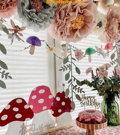 a table topped with lots of paper flowers