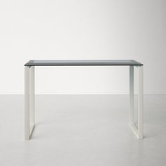 a glass table sitting on top of a white floor