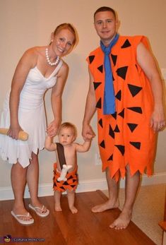 a man, woman and child dressed up in costumes