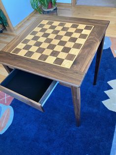 a table with a chess board on it in the middle of a blue carpeted room