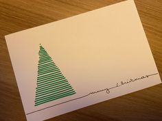 a close up of a piece of paper with a christmas tree drawn on the side