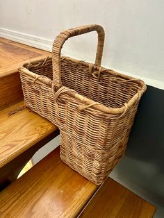 a wicker basket sitting on top of wooden steps