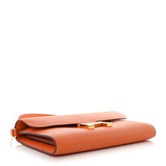 This is an authentic HERMES Epsom Constance Long Wallet To Go Wallet in Orange. This chic wallet is crafted of fine Epsom calfskin leather in orange. The wallet features a front flap, strap, and signature H gold plated press-lock. This opens to a partitioned leather interior with card slots, patch pockets, a detachable strap, and a zipper pocket. Long Wallet, Leather Interior, Patch Pocket, Card Slots, Zipper Pocket, Calf Skin, Slots, Gold Plate, Wallet