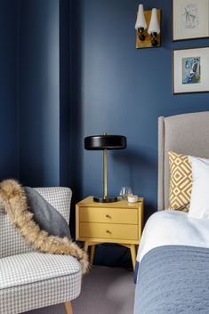 a bedroom with blue walls and white bedding