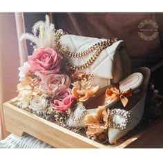 a white purse and some flowers on a table