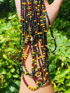 "A black, red, yellow, and green Waistbead inspired by Juneteenth. *MATERIALS USED* Beads used: Czech Glass Seed Beads Closure: tie on *DIMENSION* Length: Up to 60\" inches for Waistbeads  Up to 20\" inches for chokers/necklaces  *FOLLOW* US IG: @Strandsofparadisellc (USE MEASURING TAPE TO MEASURE WHERE YOU WANT YOUR WAISTBEAD TO BE THEN ADD YOUR MEASUREMENTS TO THE NOTES PLEASE) If you have any questions message me, I'll be happy to assist  😊 Www.Strandsofparadisellc.Etsy.com" Green Beaded Necklaces With Black Beads For Festivals, Green Beaded Necklace With Black Beads For Festivals, Green And Black Beaded Necklaces For Festivals, Handmade Multicolor Waist Beads For Festival, Green Beaded Necklace With Black Round Beads, Adjustable Multicolor Traditional Waist Beads, Traditional Adjustable Multicolor Waist Beads, Hand-strung Black Beaded Necklaces For Festivals, Black Hand-strung Beaded Necklaces For Festivals