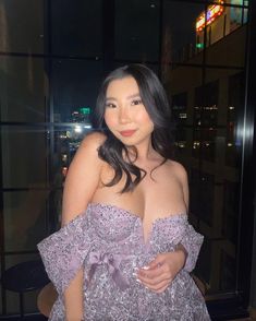 asian woman smiling wearing for purple love & lemons dress posing in front of window at nigh time For Love & Lemons