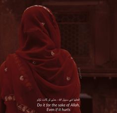 a woman wearing a red shawl with an arabic quote on the front and back