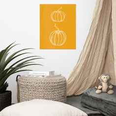 a living room with two pumpkins on the wall and a stuffed animal next to it