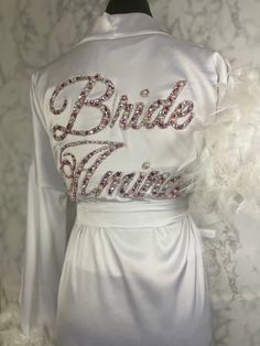 the back of a bridesmaid's wedding dress with white feathers on it