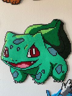 some pixelated pokemons are hanging on the wall