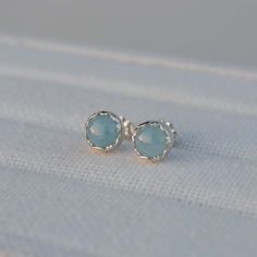 These sterling silver stud earrings feature 6mm round Aquamarine stones set in a fancy bezel.  ★ All orders come wrapped in a gift box, ready for gifting ★ Minimalist Silver Earrings With Bezel Setting, Blue Bezel Set Earrings For Gift, Blue Round Stone Earrings For Gift, Silver Bezel Set Earrings As Gift, Silver Bezel Setting Earrings For Gift, Silver Earrings With Birthstone For Her, Silver Birthstone Earrings For Her, Silver Birthstone Earrings Gift For Her, Hypoallergenic Round Cut Earrings For Gift