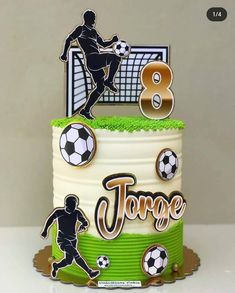 a soccer themed birthday cake with the number eight on it