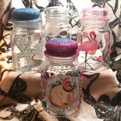 three glass jars with different designs on them