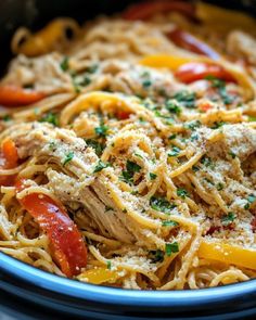 pasta with chicken, peppers and parmesan cheese in a slow cooker bowl