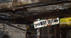 this way out sign is hanging from the ceiling