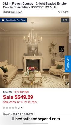 a living room with white furniture and chandelier on the ceiling is for sale