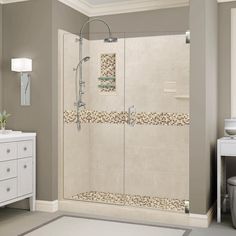 a bathroom with a walk in shower next to a white dresser