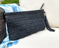 Hand crocheted raffia is teamed with a black veg tanned leather to create a lovely summer clutch. The raffia comes from a sustainable source and the leather and suede is redundant stock from a top end brand. As leather is from redundant stock the texture of leather might differ slightly from photo. Fully lined with zipped closure and finished with a detachable suede tassel. Other cols of suede tassels can also be bought to accessorise your bag. Dimensions: 170mm deep x 275mm wide Sorry but due t Summer Clutch, Suede Tassel, Veg Tan Leather, Leather Clutch, Clutch Handbag, Hand Crochet, You Bag, Evening Bags, Purses And Handbags