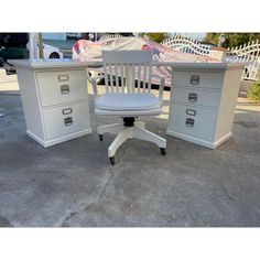 an office desk with two drawers and a chair in front of it on the concrete