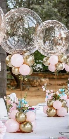 balloons and flowers are on the table for a wedding reception in pink, gold and white