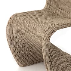 a chair made out of wicker sitting on top of a white floor