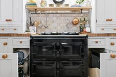 an old fashioned black stove in a white kitchen