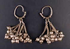 Nice and very old genuine ethnic and tribal earrings from Himachal Pradesh (India) and made with high-grade silver. It's made with a ring from which several dangles hang graciously, and made a nice sound when moving. These ethnic earrings measure approx. 9 cm high (3,54 in) and they both weight 85 gr. The gauge of the silver wire is 2 mm. IND489 They are from the end of the XIX century or the beginning of the XXth, and they come from a European collection. If sold outside the EU, the buyer is re Silver Pendant Earrings For Festivals, Silver Dangle Jewelry For Rituals, Traditional Silver Bead Drop Earrings, Silver Chandbali Earrings With Dangling Beads, Ceremonial Silver Jewelry With Latkans, Traditional Silver Danglers With Dangling Beads, Traditional Silver Beaded Drop Earrings, Traditional Silver Jewelry With Dangling Beads, Silver Ceremonial Danglers For Festivals