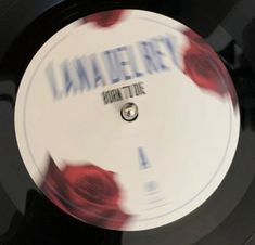 a record with the word jamery on it and some red roses in front of it