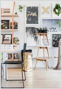 a living room filled with furniture and lots of pictures on the wall next to it